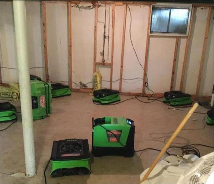 Drying equipment inside a basement. Five air movers in a basement