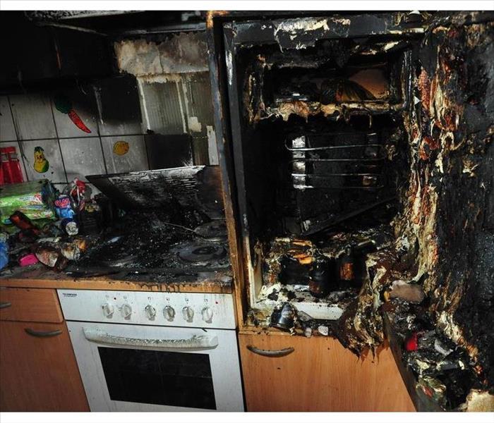 Kitchen stove and refrigerator damaged by fire